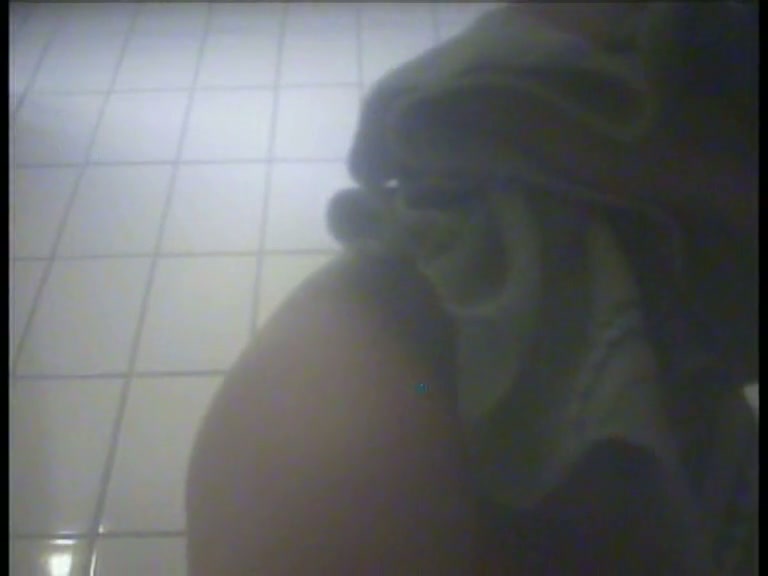This changing room spy cam video shows a girl wiping herself with a towel