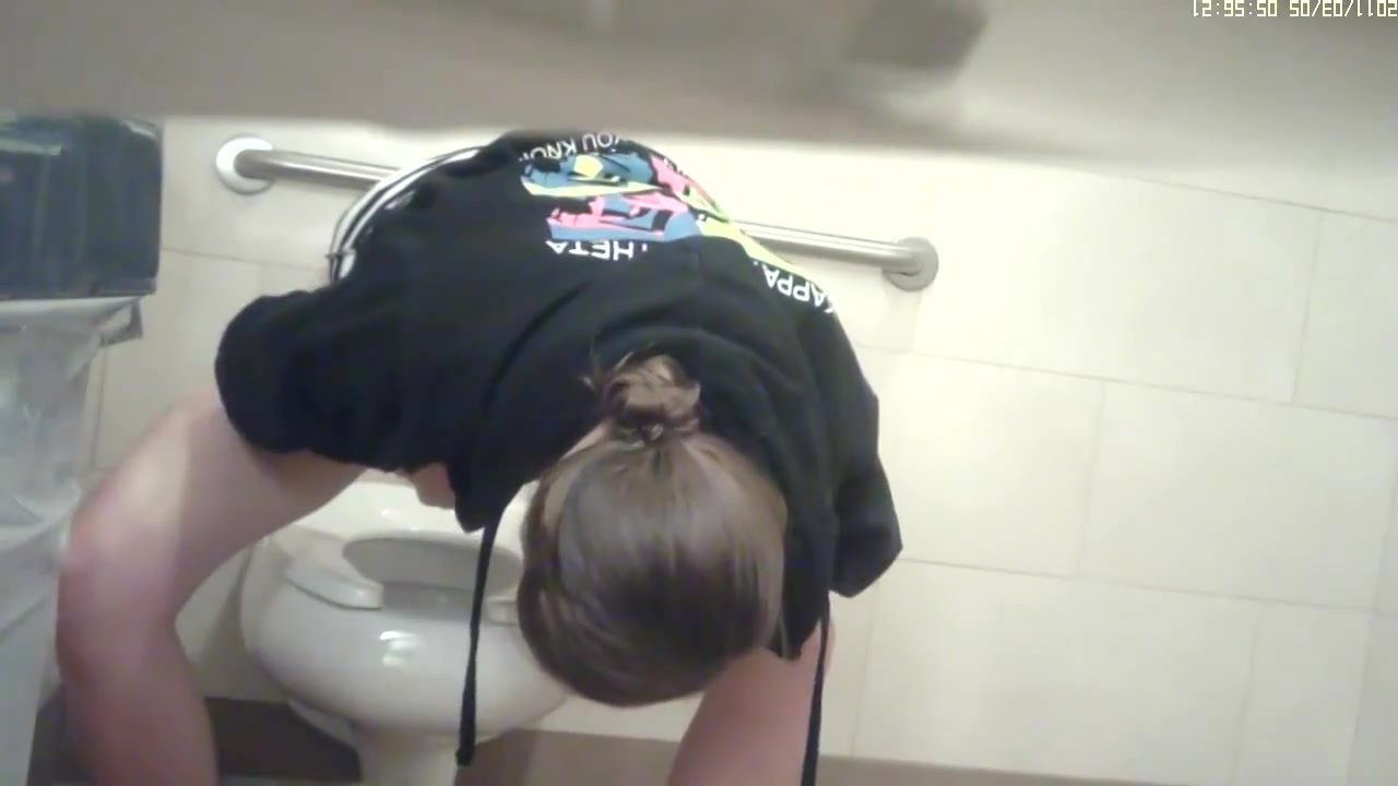 Girl pissing and stretching legs not to touch dirty bowl