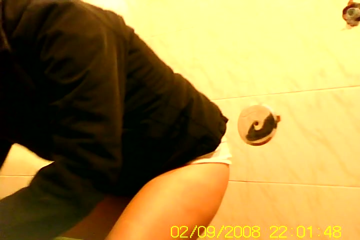 Girl in shorts pissing on toilet and getting spied on cam