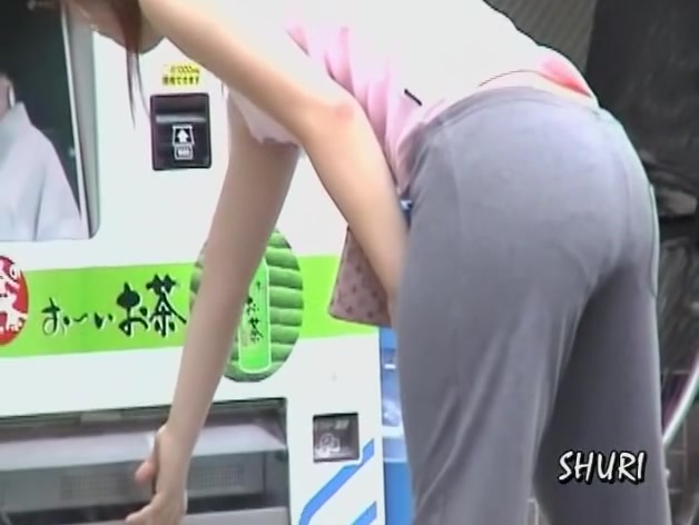 Japanese babe Street Sharking in front of a vending machine.