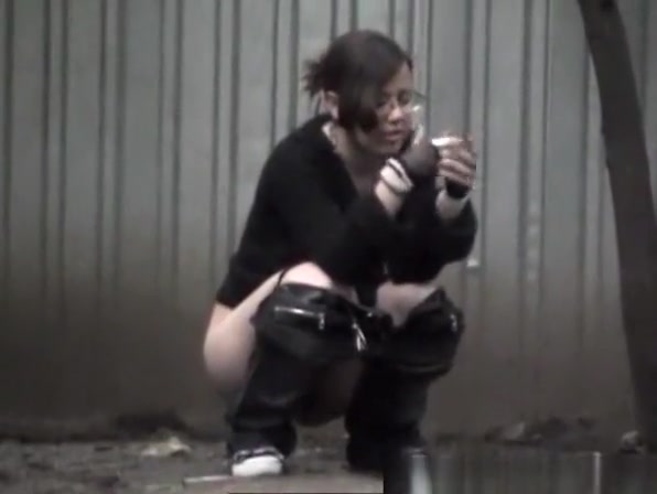Girl in glasses caught peeing outdoors